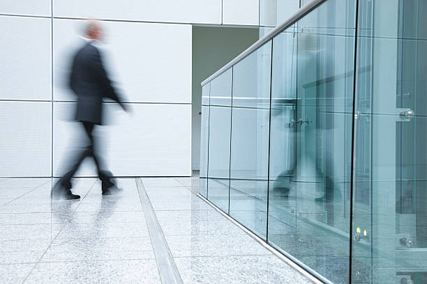 istock Businessmen walking in a modern interior 157418405