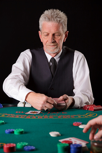 A dealer in a card game of poker.