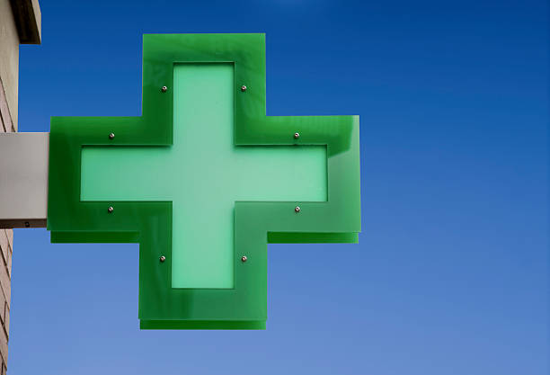 This is a shot of led lit pharmacy cross at night