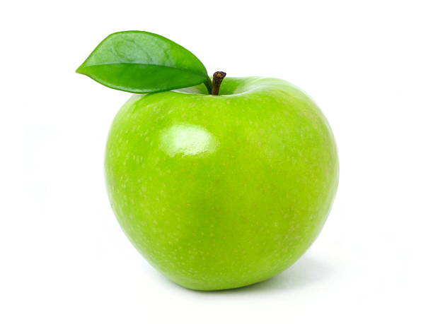 Green apple with leaf on a white backdrop stock photo