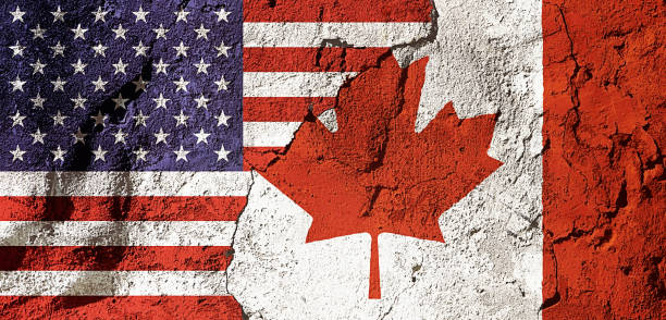 istock Flags of America and Canada overlapping on a distressed concrete wall 1574190263