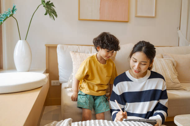 istock Single mother spending time with her son while staying at home. 1574190778
