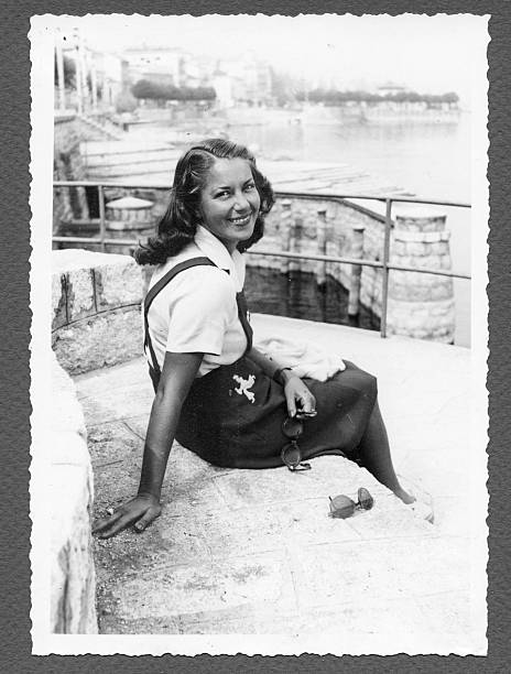 Young Woman Sitting by the Sea,1940.Black And White. Shooted in 1940. Some scratches and grain. Scanned print. 1940 stock pictures, royalty-free photos & images