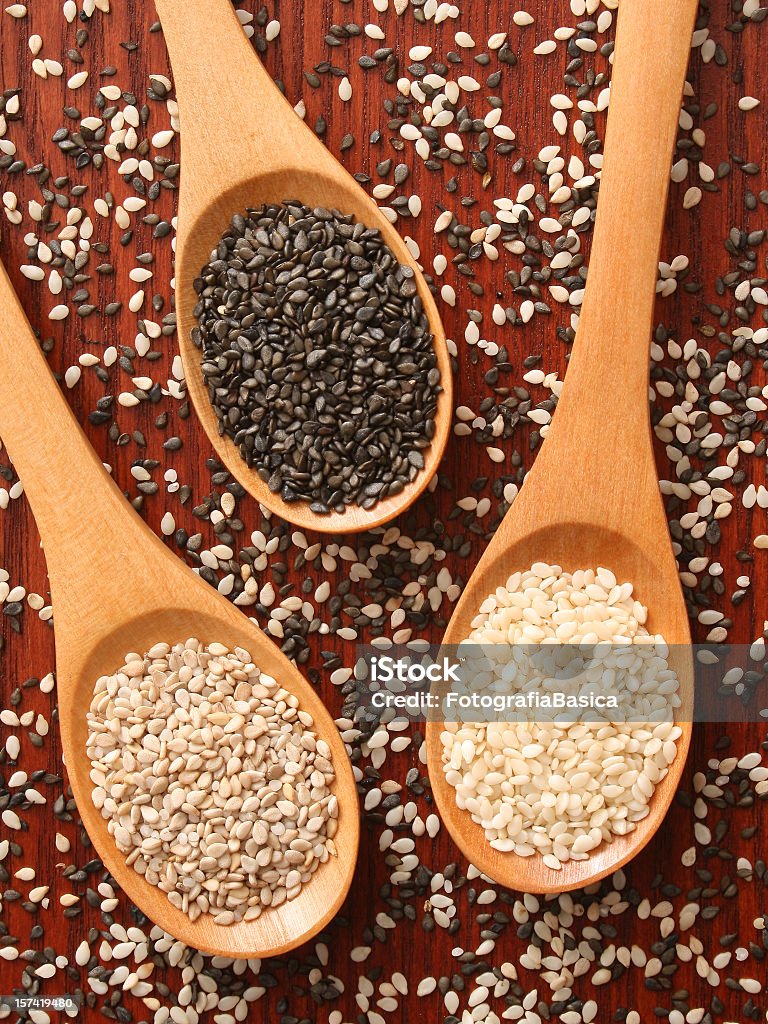 Sesame seeds types Three wooden spoons with the three types of sesame seeds: white, black and whole brown Sesame Seed Stock Photo