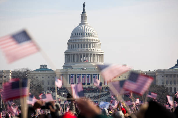 Obama inauguration at the Capitol building in Washington DC The inauguration of President Barack Obama, January 20th 2009.  Unrecognizable crowds in the Washington Mall.     2009 stock pictures, royalty-free photos & images