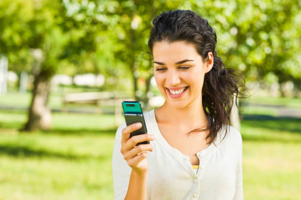 istock Young woman looking at phone and smiling 157419660