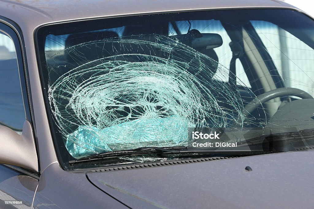 Broken windshield on a grey car Broken windshield from airbag going off from a car accident. Windshield Stock Photo