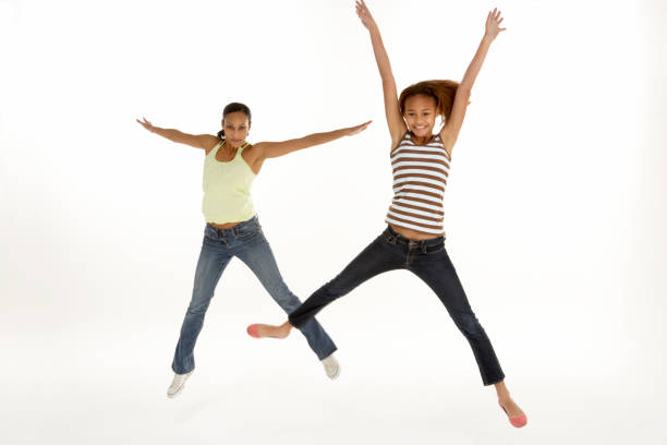 Mother And Daughter Leaping In Air stock photo