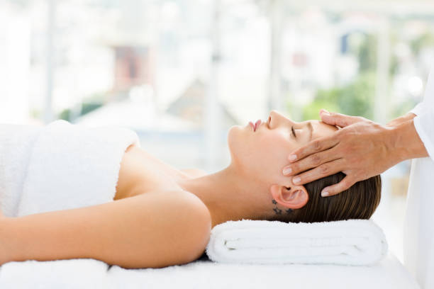 istock Young woman receiving head massage at spa 157419940