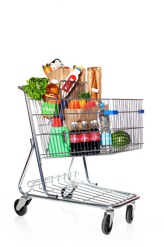 A shopping cart with various food items. Some items have generic labels ie. cola, juice, milk