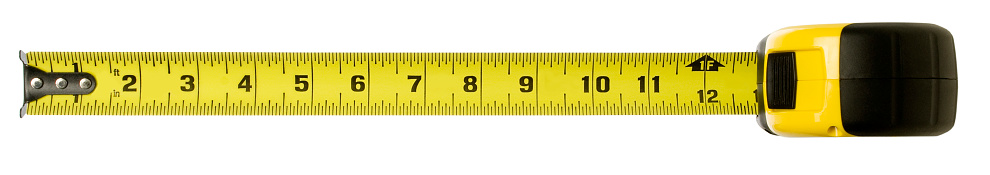 A variety of tape measures on a wooden bench