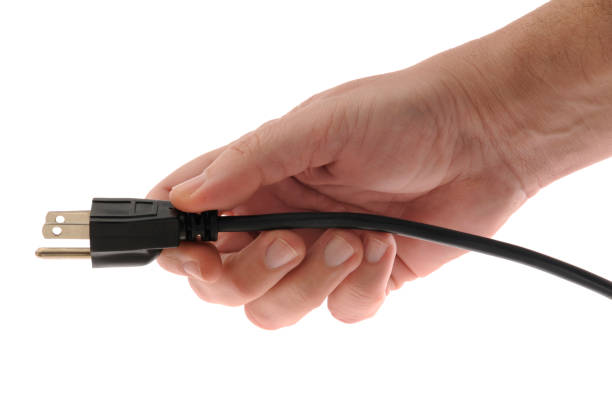Plug-In, Power-Up; Hand Holding Grounded Electrical Power Plug, White Background
