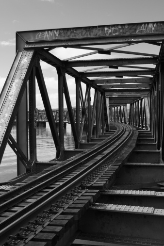 Black and white image of Railway bridge over part of Tauranga Harbour NZ. The line is the main trunk line through this part of the North Island