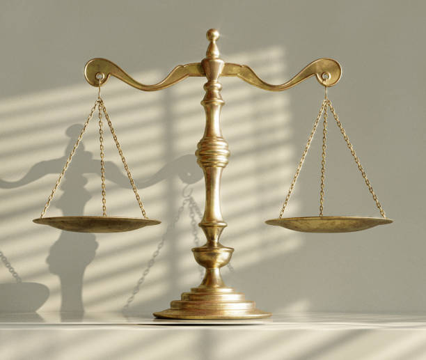 istock Scales Of Justice And Shadows 1574209033