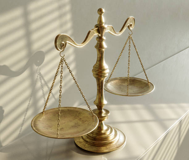 istock Scales Of Justice And Shadows 1574209034