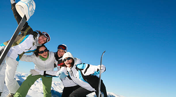 Four Friends Skiing - copy space stock photo