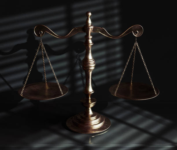 istock Scales Of Justice And Shadows 1574210158