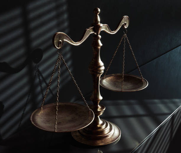 istock Scales Of Justice And Shadows 1574210713
