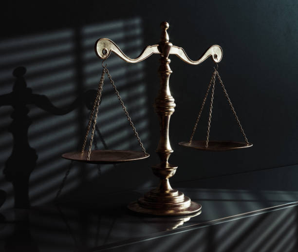 istock Scales Of Justice And Shadows 1574211247