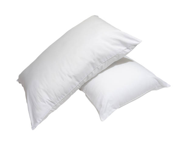 istock White pillows in stack in hotel or resort room isolated on white background with clipping path. Concept of comfortable and happy sleep in daily life 1574212903