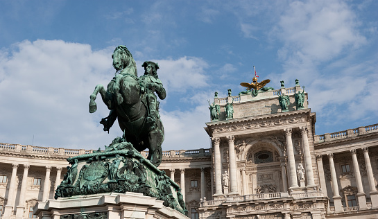 Dramatic wide angle view of the Hofburg Palace complex in Vienna, Austria (Statue of Price Eugene in the front)