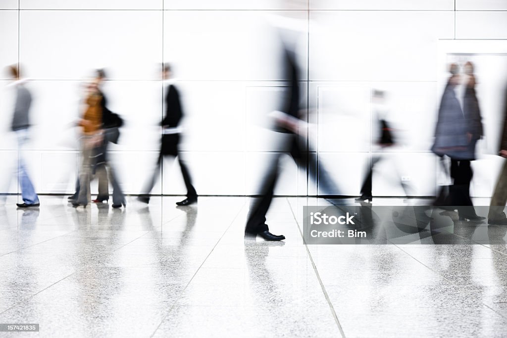 Motion Blurred People Walking Down Corridor blurred and defocused people walking, "high key" People Stock Photo