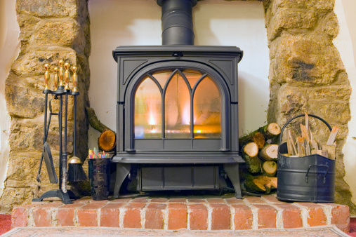 A wood burning stove in a traditional country cottage.