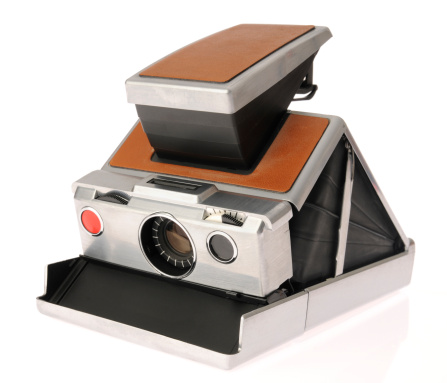 This is a classic instant camera made of stainless steel with leather. It is an SLR with a rubber bellows which allowed the camera to be collapsed. Instant cameras made prints on the spot, and were the predecessors to digital cameras where instant gratification was concerned.