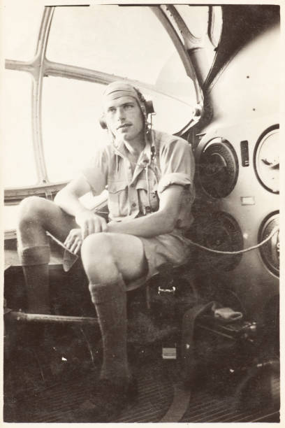 Vintage photograph of an RAF reconnaissance and navigation officer sitting beside the observation blister window aboard a Consolidated Catalina flying boat in East Africa during WWII. This is a British member of 209 Squadron that, along with an American crew, spotted the German battleship Bismarck which was subsequently sunk.