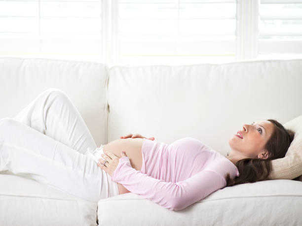 istock Pregnant woman relaxing on a couch 157422454