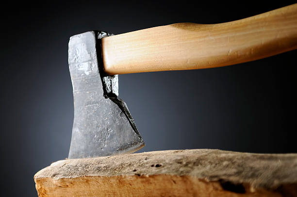 istock Large, heavy steel ax with wooden handle stuck in log 157423043