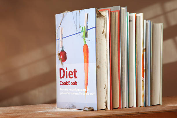 Diet cookbook on shelf with other books stock photo