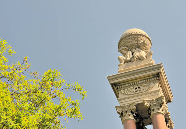 Historic building in Novi Sad, Serbia, featuring a statue of Mercury atop a domed roof. The architecture showcases aged details, faded blue paint, and classical ornamentation — a charming symbol of the city’s heritage