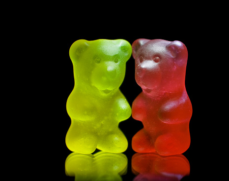 Gummy bear couple close up isolated on black