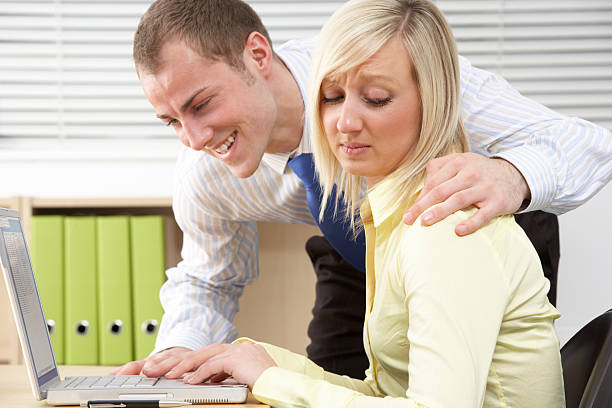 Businesswoman Harassing Female Colleague stock photo