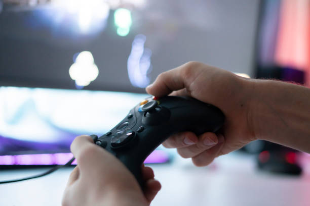 istock gamer holding a gamepad controller and playing the video game 1574238031