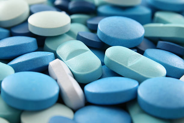 Blue pills closeup stock photo
