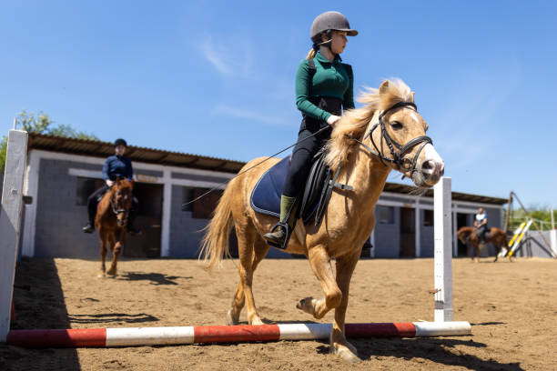 istock Girls riding horses 1574240817