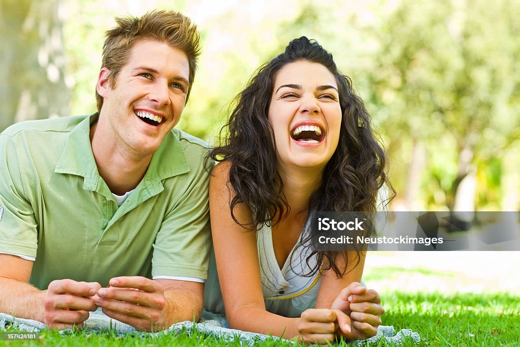 Young couple lying and enjoying at park Closeup of young couple lying and enjoying at park Adult Stock Photo