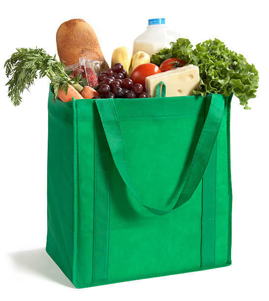 Close-up of reusable grocery bag filled with fresh produce A reusable/recyclable grocery bag filled with fresh groceries. Be Green! bag stock pictures, royalty-free photos & images