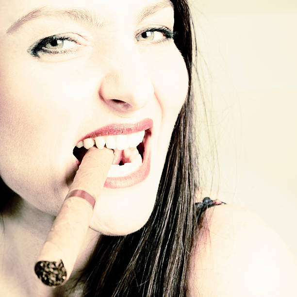 istock Cheeky woman smoking cigar 157424329