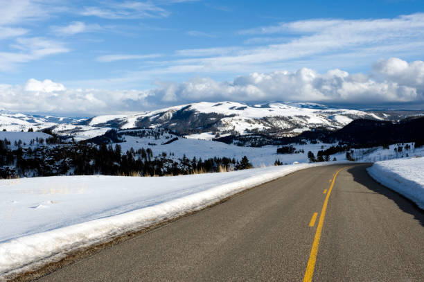istock Mountain road in winter with powder snow and clouds 157424445