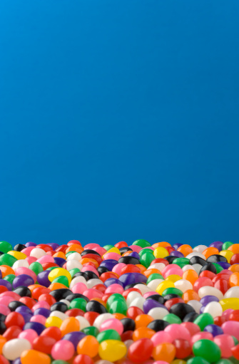 Jellybeans fill the lower 1/3 of the frame, Jellybeans in front are out of focus, those in back are in focus. Clipping Path around Jellybeans so the blue can be removed or changed.