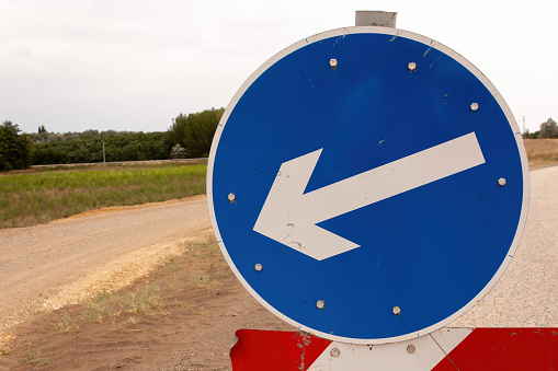 Close-up of a traffic sign on the road end.