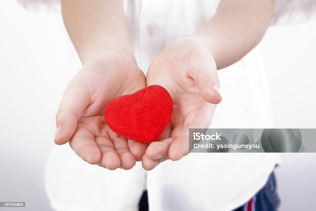 Child's Heart - Charity Child Holding Heart with on White Background. (Focus on Foreground) 4-5 Years Stock Photo