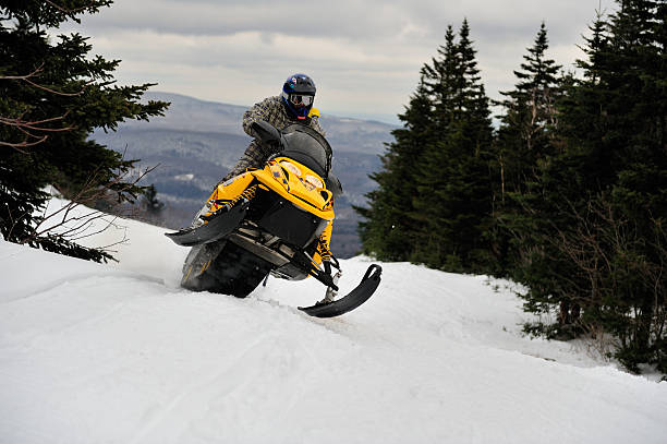 istock Snowmobiler rides hard and fast through the mountain pass 157424891
