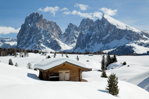 Winter scenics with wooden shed and Langkofel mountain (Dolomites, Italy)