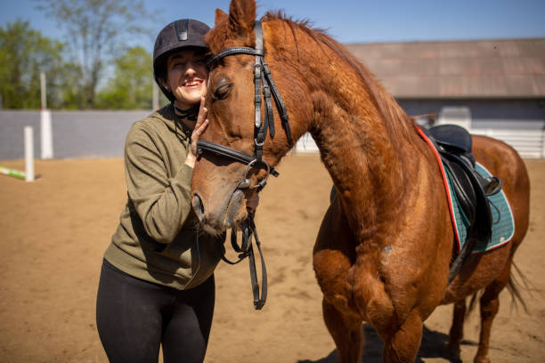 istock Woman hugging a horse 1574251809