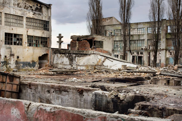 Destroyed industrial building and courtyard on crisis time stock photo