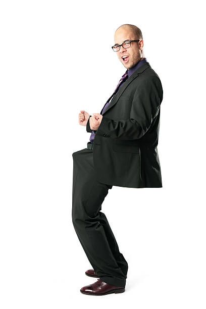 Funny excited young businessman celebrating his erection...
